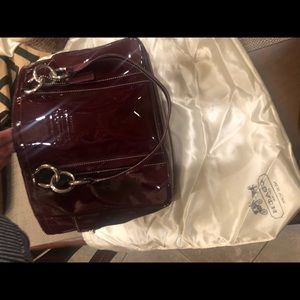 Deep red patent leather hand bag.